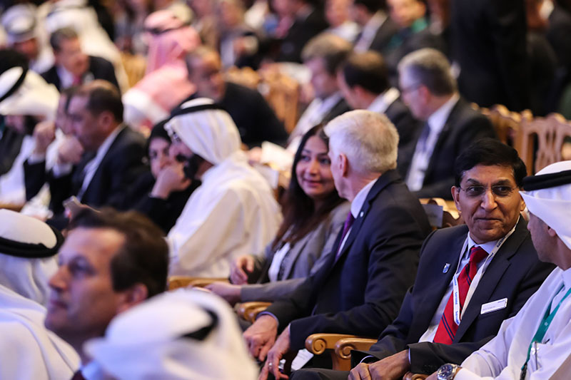 Group of people attending Arab Health in the past sitting in an auditorium.